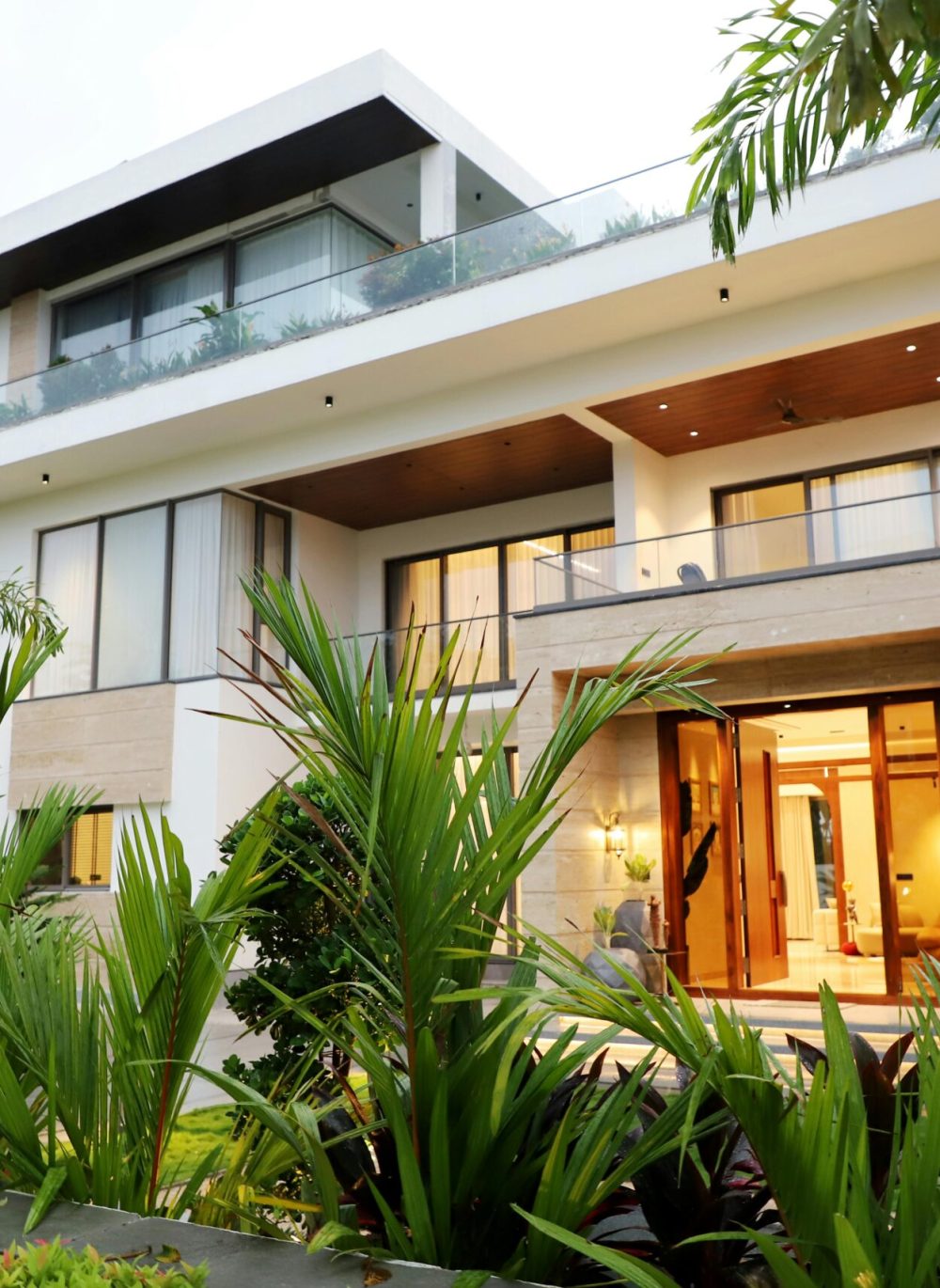 A modern luxury villa surrounded by lush greenery, showcasing contemporary architectural design.